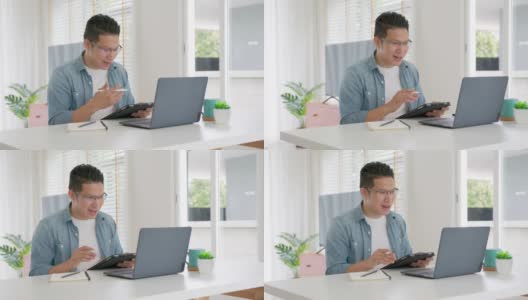 慢动作跟踪镜头:商人在视频会议中讲话。亚洲团队使用笔记本电脑和平板电脑进行在线视频会议。在家工作，远程工作和自我隔离。高清在线视频素材下载