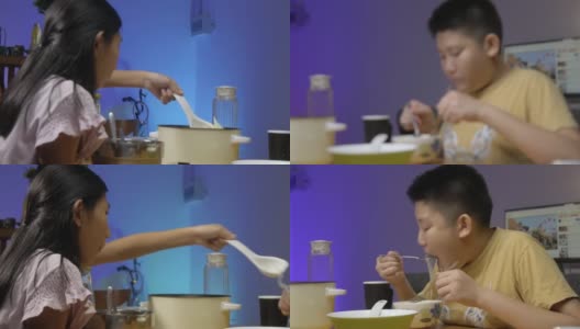 快乐的亚洲儿童享受晚餐涮涮锅或素喜烧在家里，led灯光背景。高清在线视频素材下载