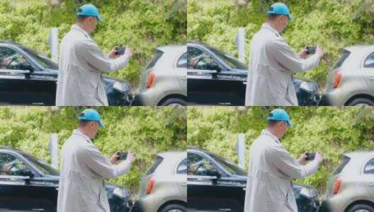 HD Man保险代理人用智能手机拍摄车祸照片。两辆破车接连停在路上高清在线视频素材下载