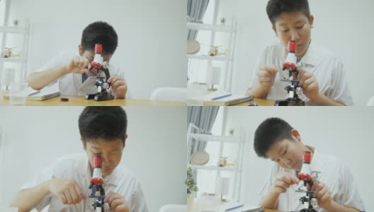 亚洲男生穿着实验服在科学课上使用显微镜，教育理念。高清在线视频素材下载