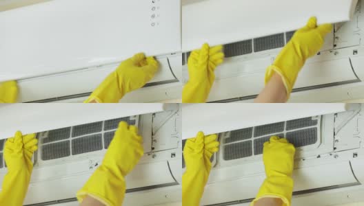 戴黄色手套的手打开空调前盖，取下过滤网进行清洁。家务劳动或技术服务公司工作的概念高清在线视频素材下载