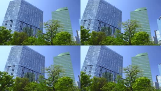 Pan拍摄了美丽的新绿和城市建筑高清在线视频素材下载