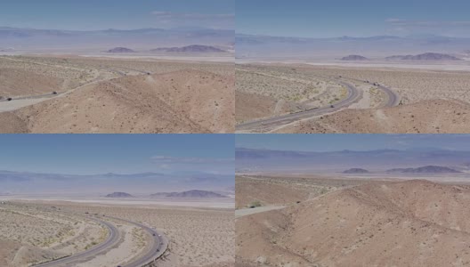 无人机飞越山坡，显示加州Zzyzx附近的I-15高清在线视频素材下载