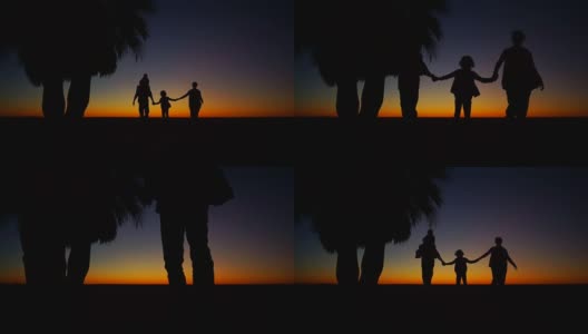 妈妈，爸爸和两个孩子在海滩上散步。夕阳下一家人的剪影。浪漫的周末高清在线视频素材下载