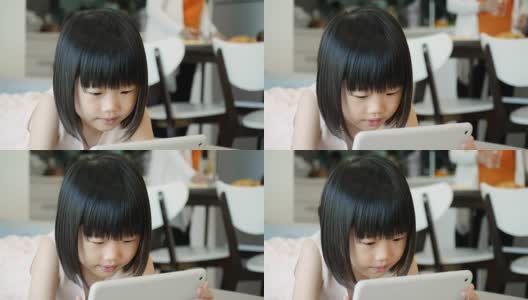 小女孩用平板电脑看她最喜欢的节目高清在线视频素材下载