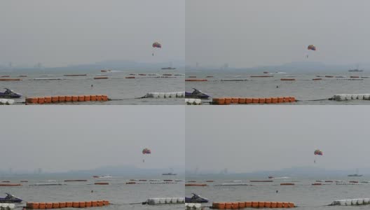 帆伞运动中，一个人用降落伞为一艘船飞行。泰国芭堤雅高清在线视频素材下载