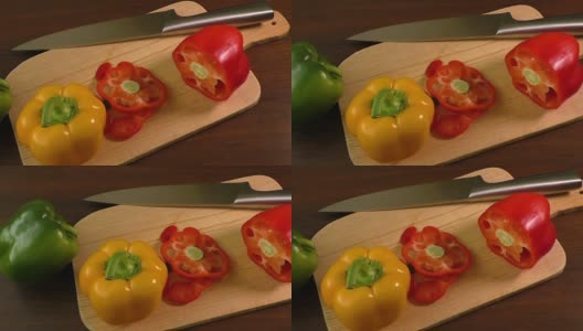 在切菜板上切甜椒，包括红、黄、绿高清在线视频素材下载