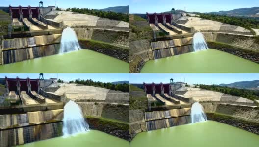 巨大的水坝和水流流在绿色的河流高清在线视频素材下载