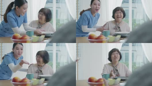 迷人的年轻老年亚洲公民夫妇幸福的坐在餐桌上，聊天，吃汤的健康营养早餐餐在日常生活方式在老亚洲护理居家护理。高清在线视频素材下载