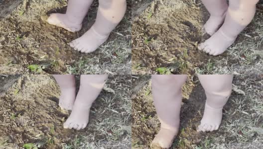 可爱的凌乱的婴儿脚踩在泥与水高清在线视频素材下载