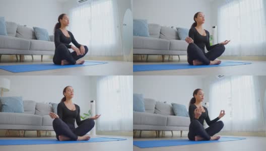 拉丁美洲年轻美丽活跃的女人做瑜伽普拉提锻炼在家里。漂亮的女孩穿着运动服，在家里的客厅里跟随在线教练的运动指导视频，感到快乐和放松高清在线视频素材下载