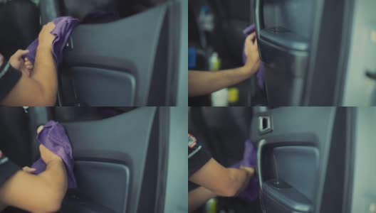 在汽车详细清洁服务期间，一位年轻人在清洁座椅坐垫时使用精细的布对汽车内部进行深层清洁。高清在线视频素材下载