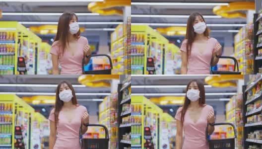 亚洲妇女戴着口罩，拿着购物篮在超市购物。在冠状病毒危机或新冠肺炎爆发期间，女孩在货架上挑选、寻找食物。高清在线视频素材下载