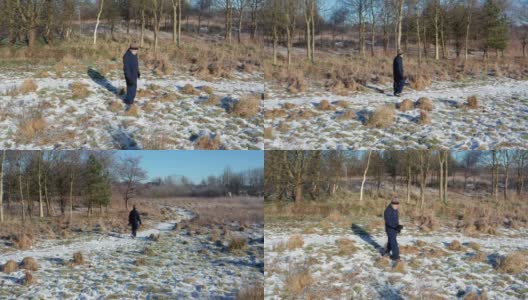 在苏格兰西南部，一位老人独自走在一条被雪覆盖的人行道上高清在线视频素材下载