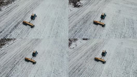 在冬季使用拖拉机在白雪皑皑的土地上用杀虫剂施肥的农机鸟瞰图高清在线视频素材下载