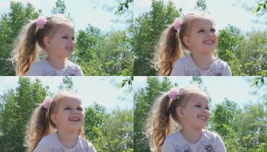 一个可爱的快乐女孩的肖像看着一边。观察自然。婴儿的积极情绪。一个快乐的孩子的微笑。高清在线视频素材下载