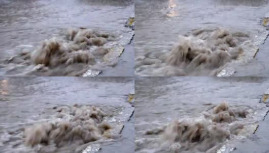 雨后的洪水顺着道路的排水沟流下去高清在线视频素材下载