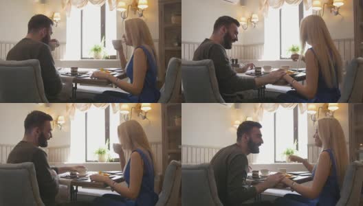 一对年轻的白人夫妇在咖啡馆里喝着咖啡高清在线视频素材下载