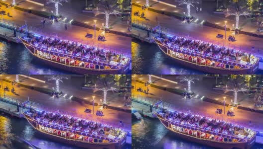 在迪拜滨海湾的旅游木船在夜晚发光的时间流逝高清在线视频素材下载