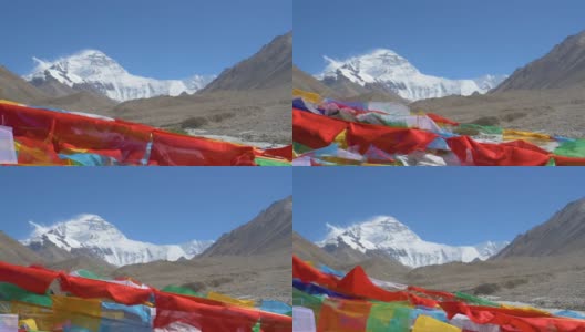 慢动作:佛教旗帜在雪山前飘扬的电影镜头高清在线视频素材下载