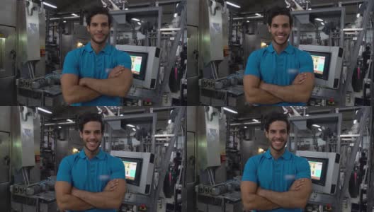 年轻英俊的男子工作在一个胶印机厂面对镜头微笑高清在线视频素材下载