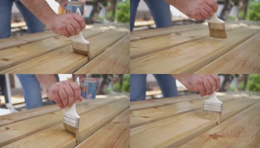 精密的木匠正在给加工过的木板上涂清漆高清在线视频素材下载