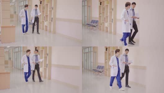 在走廊走廊医院，年轻的亚洲医生在私人病房与概念晨间病房一起散步、交谈、讨论、放松。诊所日常医疗工作。高清在线视频素材下载
