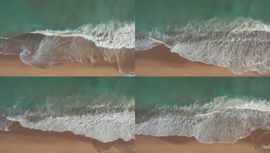 金沙海浪和绿松石海水与白色泡沫从小海浪风景鸟瞰图。暑假的概念。明亮的抽象背景适合任何设计。无人机的幻灯片高清在线视频素材下载