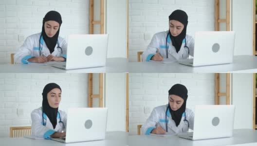 一名戴着头巾的妇女正在接受在线培训，以提高她作为一名医生的资格。穆斯林国家的医学教育。这位未来的医生正在录制一场关于治疗的演讲高清在线视频素材下载