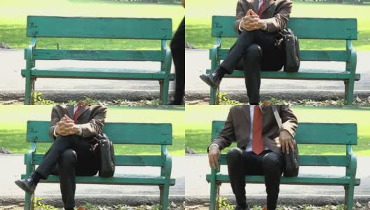 亚洲年轻的商人坐在一个公园的木凳上放松高清在线视频素材下载