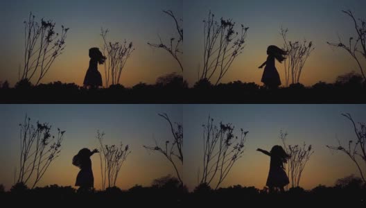 一个小女孩旋转着夕阳的剪影高清在线视频素材下载