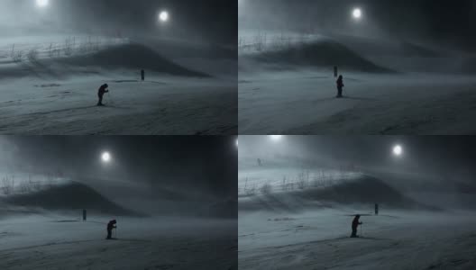 一个小男孩在暴风雪的夜晚去滑雪高清在线视频素材下载