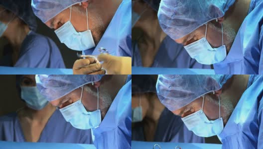 关闭男性外科医生手术室高清在线视频素材下载
