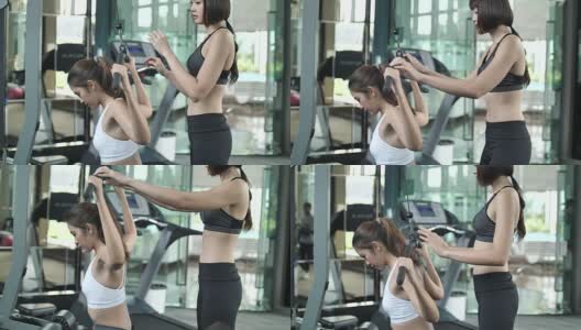 女人在健身房与私人教练健身高清在线视频素材下载