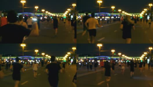 夜城跑，LED灯下的人群跑，午夜跑，每年夏季举行的短距离跑马拉松比赛，模糊中认不出的人高清在线视频素材下载