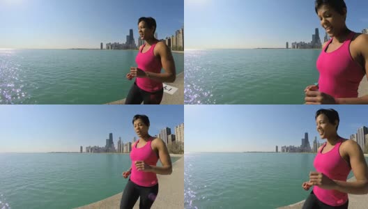 非裔美国女性沿着芝加哥城市海岸线跑步高清在线视频素材下载