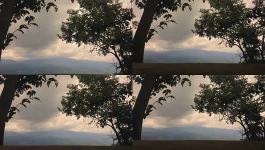 热带山脉上空云雾的时变图以木桌为前景，还原色调高清在线视频素材下载