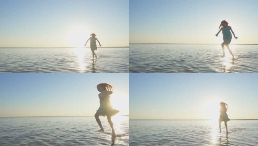 快乐的小女孩在日落的时候在大海里奔跑和享受高清在线视频素材下载
