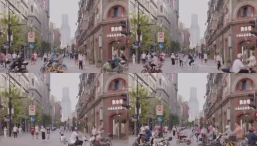 中国上海繁忙的十字路口，电动自行车快速穿过十字路口。中国上海南京路商业街高清在线视频素材下载