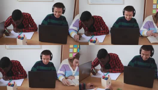 多种族学生在一起学习的同时阅读书籍和使用笔记本电脑-学校的概念高清在线视频素材下载