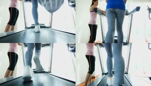 健身女性在跑步机上与健身教练在健身房，有氧训练的概念高清在线视频素材下载