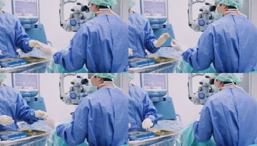 仪器护士在手术过程中为眼科医生、外科医生增加手术工具，并在faco机的打字监视器触摸屏上进行眼、白内障手术、近景、手术高清在线视频素材下载
