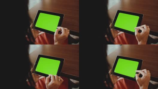 女性在餐桌上使用平板电脑。绿屏高清在线视频素材下载