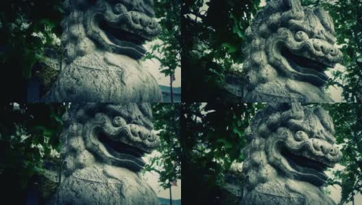 寺庙门口的石狮、历史纪念物、晃动的树影。高清在线视频素材下载