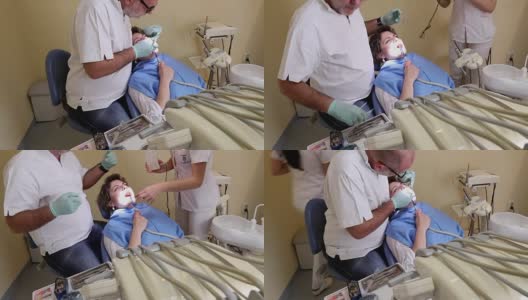 牙医治疗女病人牙齿，手持射击高清在线视频素材下载