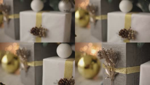 时尚的白色内饰手工礼品和礼物装饰丝带和凸起的圣诞树。温馨的家满是金色的装饰品、彩灯和花环高清在线视频素材下载