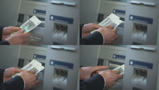 一名男子数着从ATM中取出的俄罗斯卢布，把现金放进钱包，旅行高清在线视频素材下载