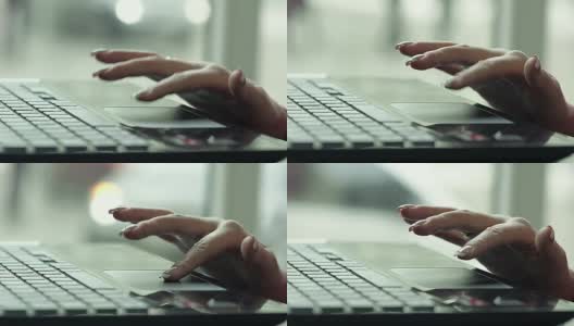 Close Up of a Female Hand Using a Laptop in a Cafe Near the Window .一个女性用笔记本电脑的近距离镜头高清在线视频素材下载