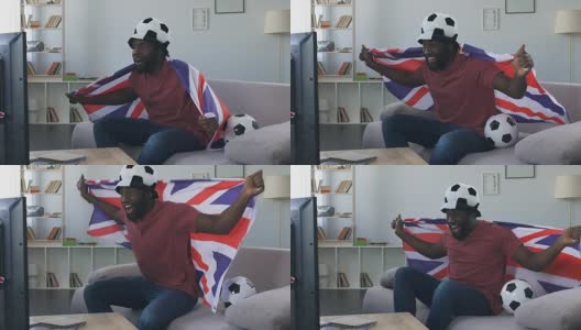 英国球迷庆祝国家队的胜利，带着国旗跳起来高清在线视频素材下载