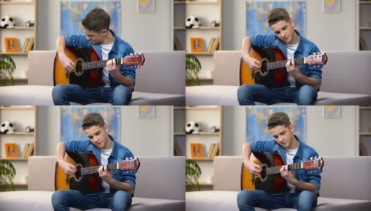 开朗的白人少年弹吉他，享受着自己的爱好，休闲高清在线视频素材下载